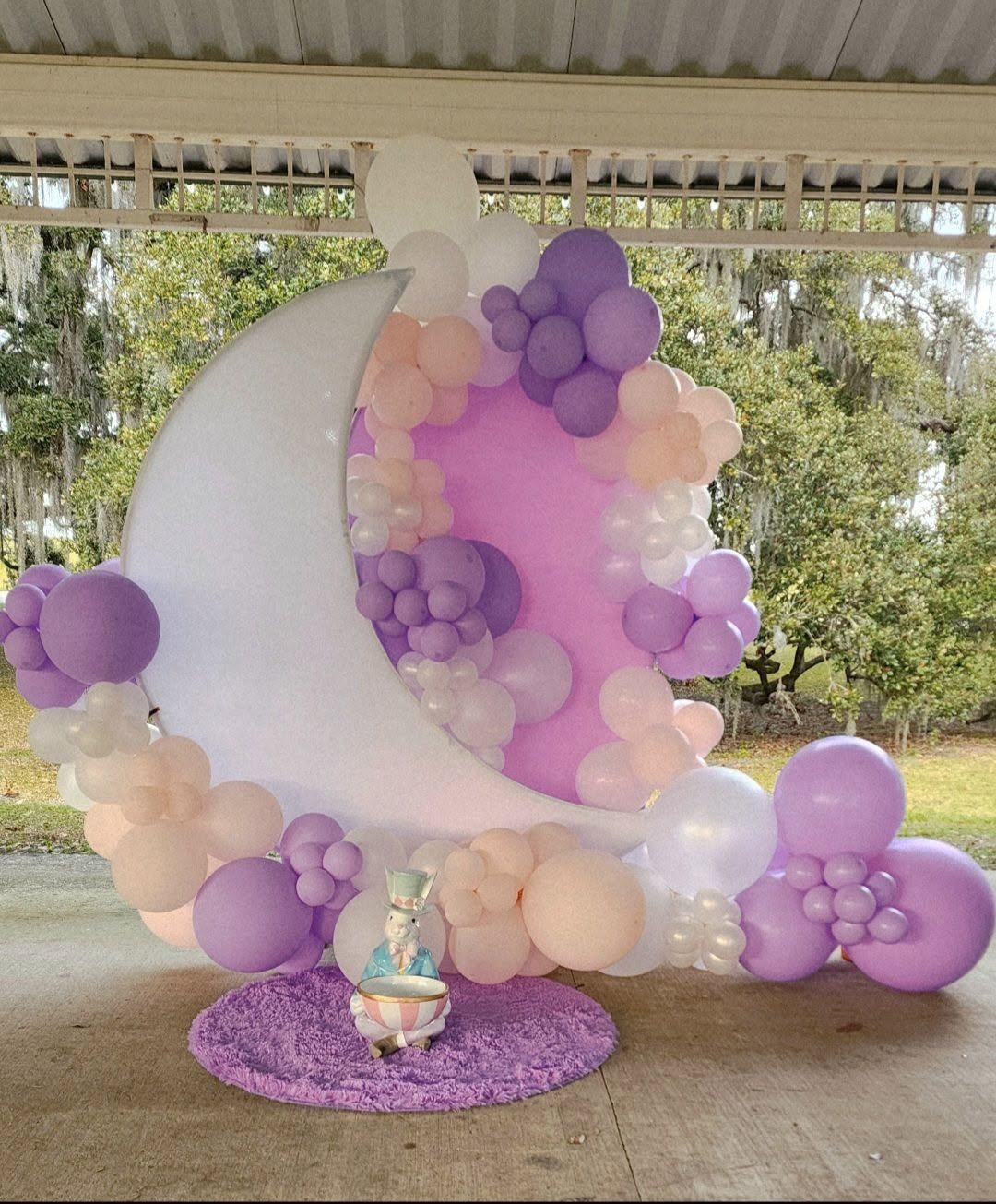 Crescent moon backdrop framed with lavender, blush and white balloons