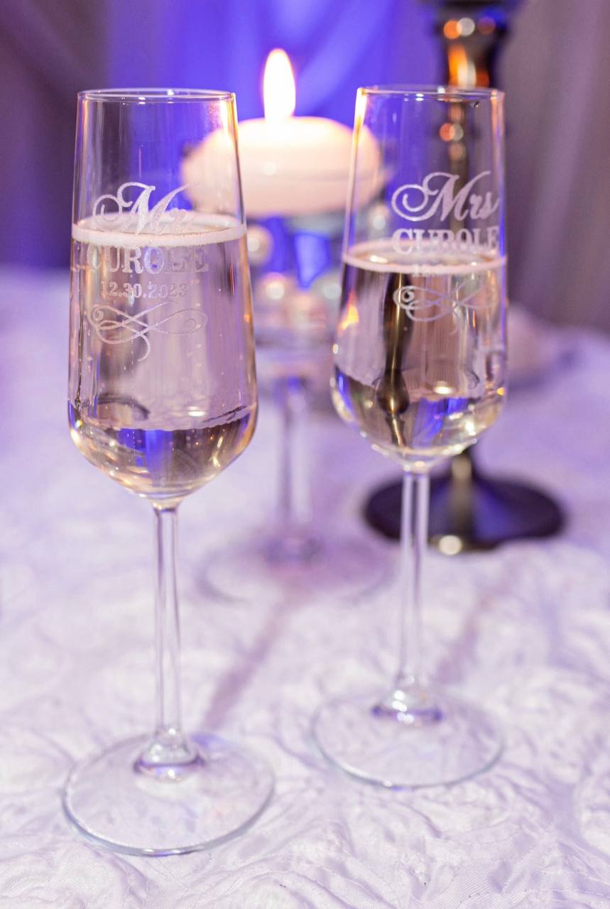 Engraved Mr and Mrs champagne flutes by candlelight
